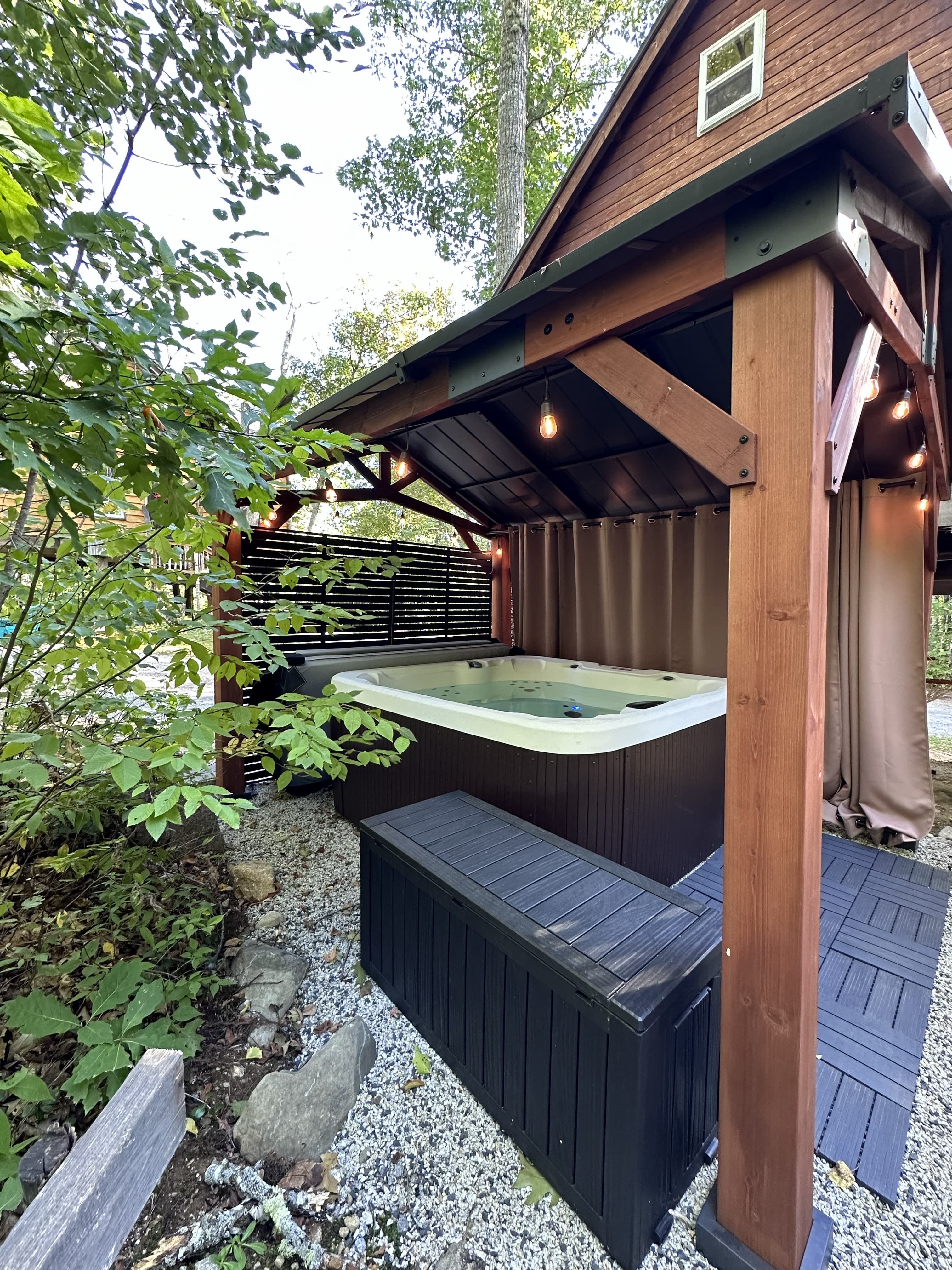 The private hot tub under its covered gazebo beside the Spruce Suite